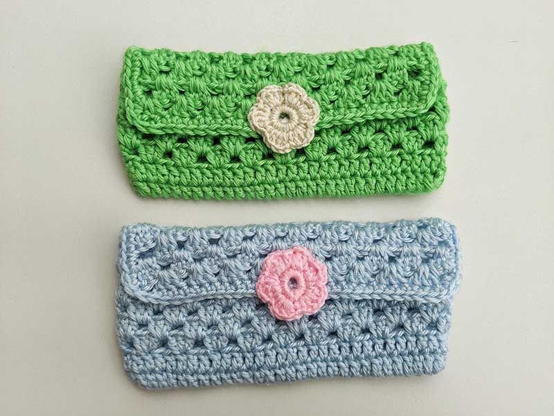 two crochet sunglasses holders - one on a button and another one on a magnetic snap