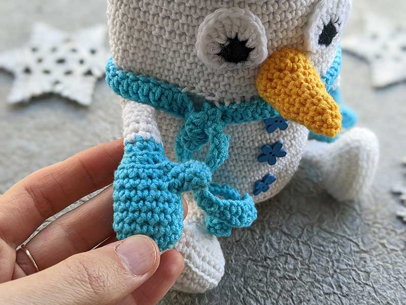 cute hand mitten of a crochet snowman bottle cover