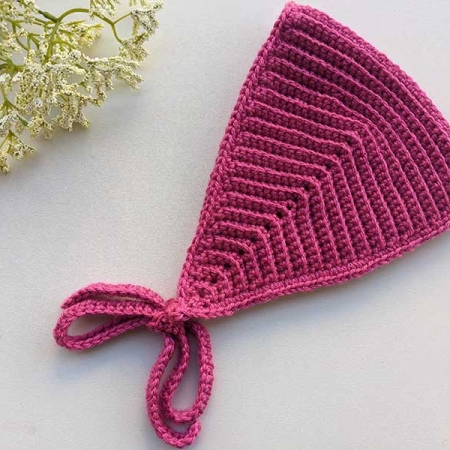 crochet bandana with ties on a flat surface