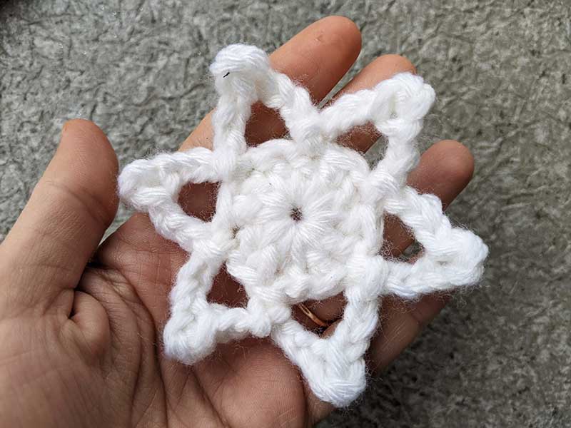 Crochet Christmas star snowflake on a hand