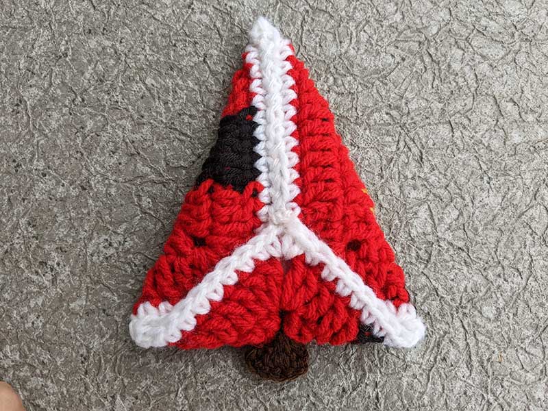 folding and sewing crochet Christmas tree from granny square - step three