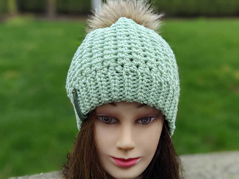 frosty charm crochet beanie on the mannequin head - front side view