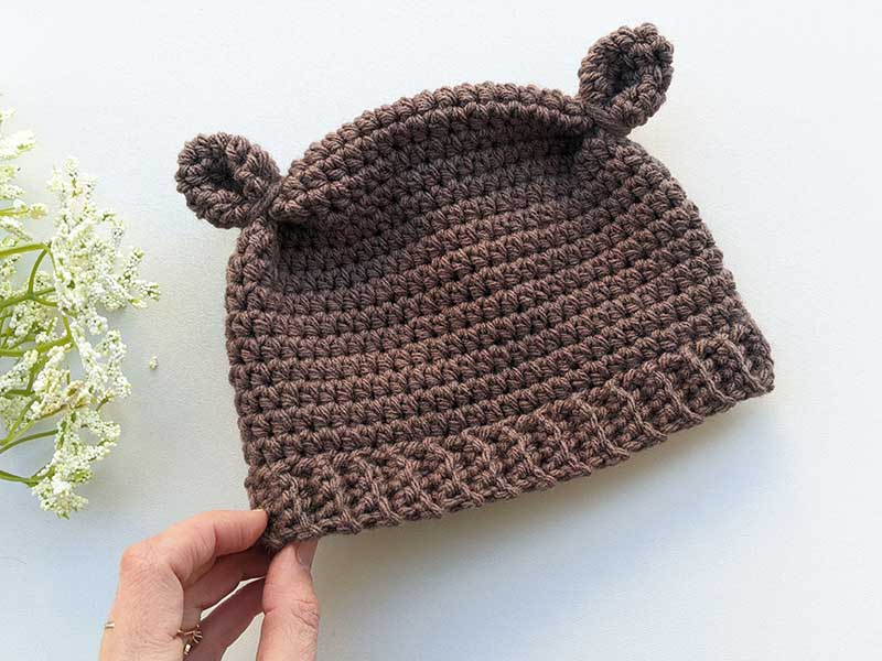 crochet teddy bear hat on a flat surface