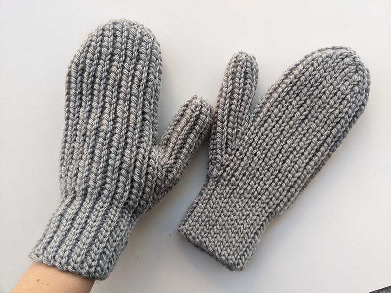 crochet woman's flat mittens on female hands