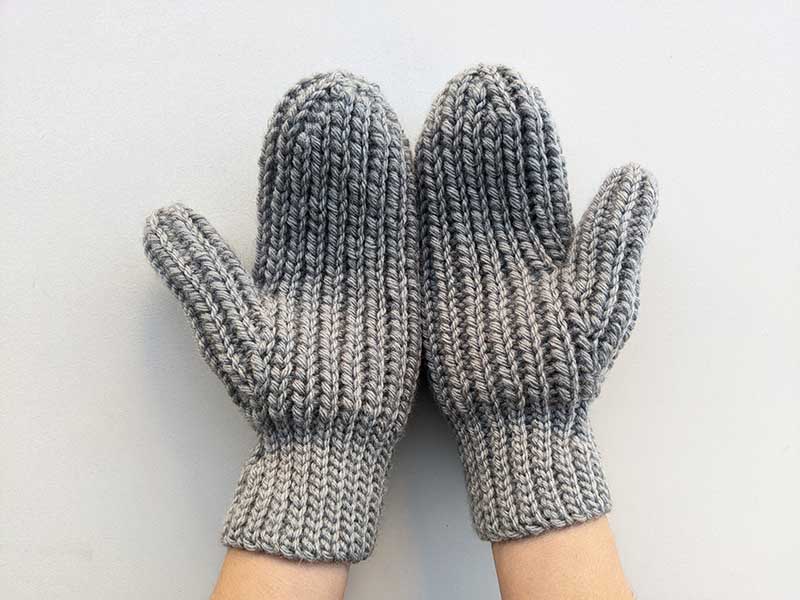crochet woman's flat mittens - palm side view on female hands