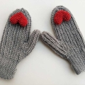 crochet woman's flat mittens with small red heart decor elements on the peak of each mitten