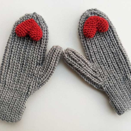 crochet woman's flat mittens with small red heart decor elements on the peak of each mitten