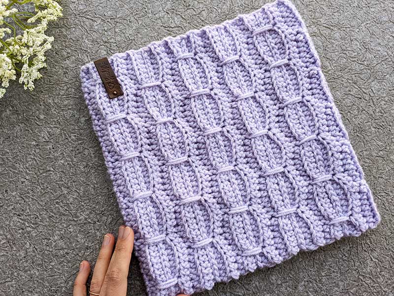 crochet wavy stitch cowl on a flat surface