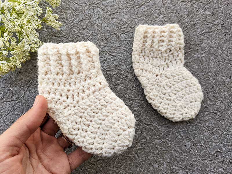 a pair of crochet preemie baby socks