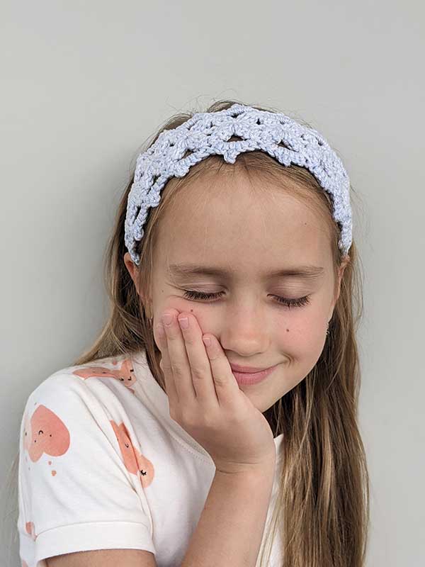 crochet lace headband on a girl model - frontal view