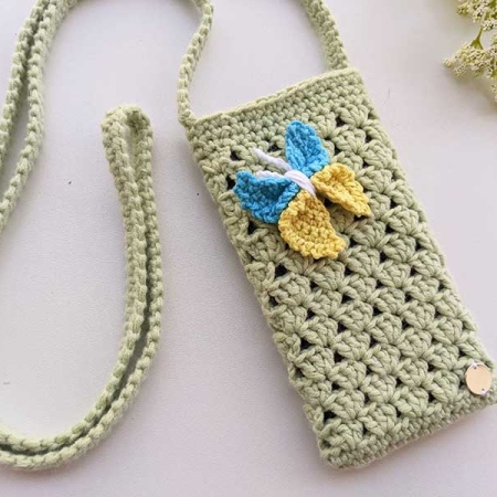 crochet phone shoulder bag decorated with a crochet butterfly