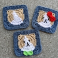 three crochet granny squares with a kitty face