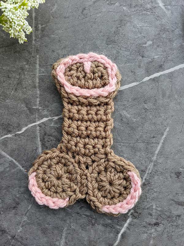 crochet dark brown willy with pink decor elements