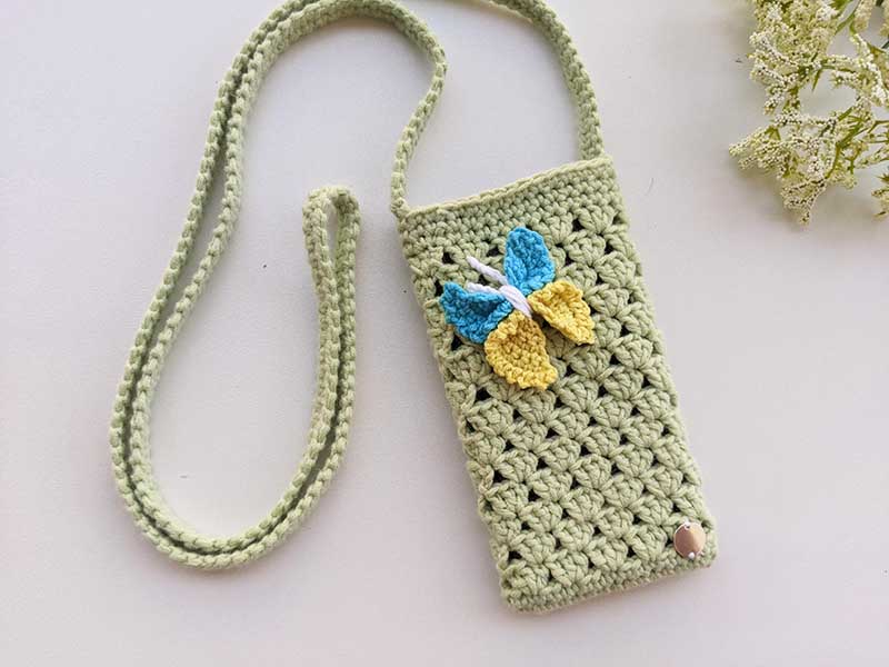 crochet butterfly decorating a phone bag