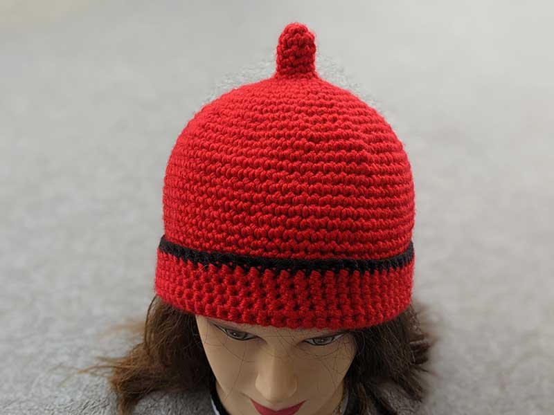 crochet teletubby hat on a female model - front-side view