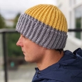 crochet two-color hat on a male model - left side view