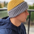 crochet two-color hat on a male model - right side view