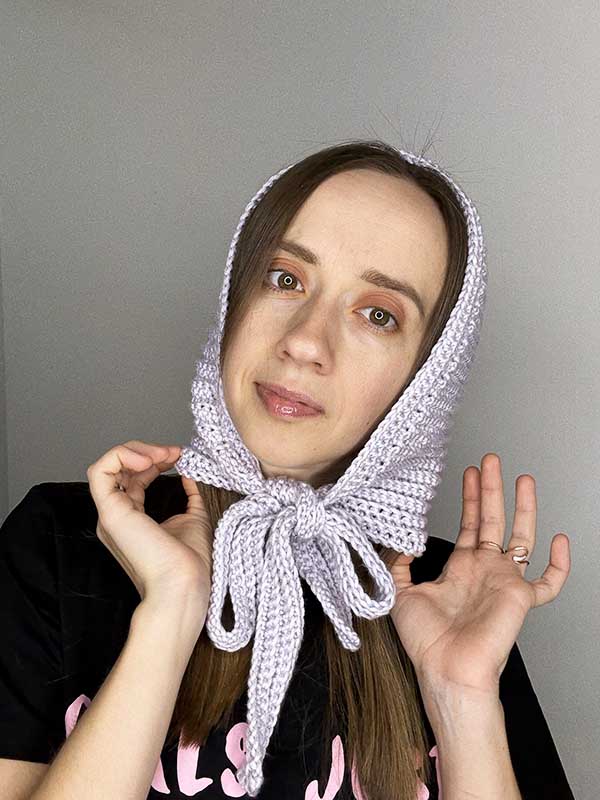 crochet hood style bonnet on the female model - front side view
