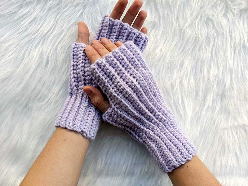 crochet ribbed fingerless gloves worn on the crossed over hands