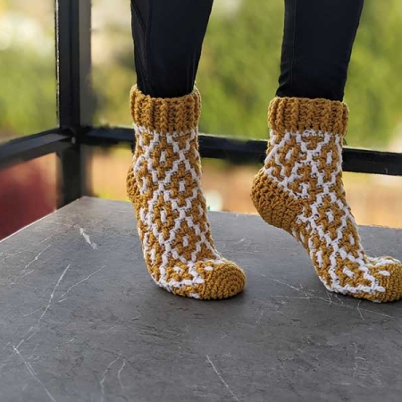 crochet snug mosaic socks on female model's feet