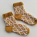 crochet snug mosaic socks on a flat surface