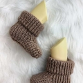 crochet ribbed baby booties on the mannequin's feet