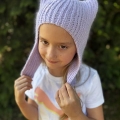 crochet kitty hat with earflaps on a girl model - front-side view